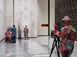 Three-dimensional geometric metal sculptures in a modern interior setting.