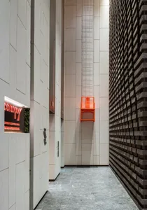 Modern minimalist hotel entryway with metallic accent