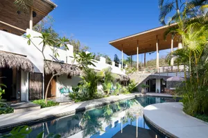 Modern resort with swimming pool and palm hut