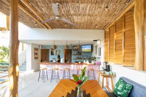 A spacious cafe bar with wooden elements and a bar counter.