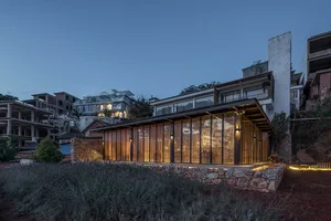 A modern building with large glass windows and wooden accents.