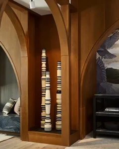 A modern interior design featuring wooden arches and a sculptural floor-to-ceiling installation.