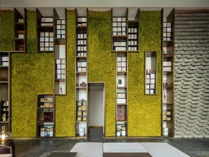 A modern library interior with living walls and wooden shelves.