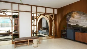 A modern living room featuring wooden elements and a cozy fireplace.