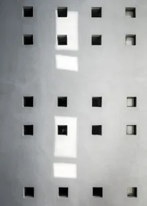 A minimalist block wall design made of concrete blocks.