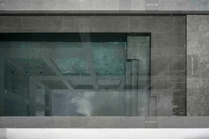 Minimalist architectural design featuring concrete materials in a technical drawing format.