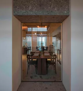 Modern dining room featuring wooden tables and glass walls.