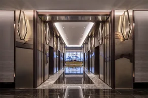 Modern interior of a fashionable hotel hallway with glass mirrors and brass handles and details