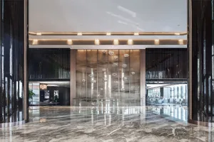 A modern hotel lobby featuring a spacious and elegant marble floor.