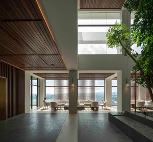 Modern hotel lobby featuring sleek, minimalist design with extensive use of glass and natural light.