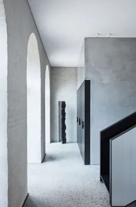 A modern interior space featuring concrete walls and floors.