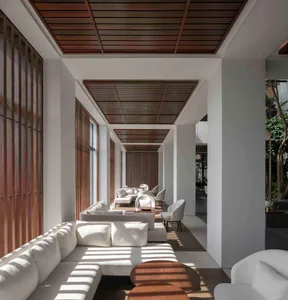 A modern living room with white wooden paneled walls and furniture.