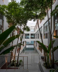 A modern residential space featuring concrete and glass materials.