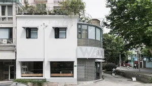 Modern commercial building with large glass windows and concrete facade.