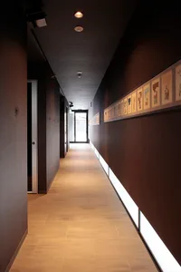 A modern corridor with granite flooring and artwork on the walls.