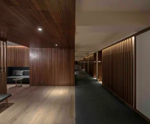 A modern corridor with wooden walls and textured flooring.