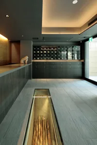A modern interior design of a concrete lobby with a glass case.