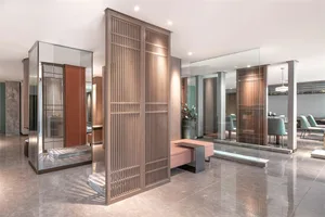 Modern lobby featuring glass panels and ambient lighting.