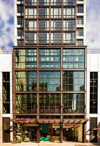 Modern office building with large glass windows and steel framing.