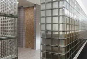 A modern stairwell with walls built from frosted glass bricks
