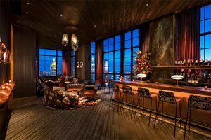 Modern industrial-style bar area with marble finishes and wooden seating