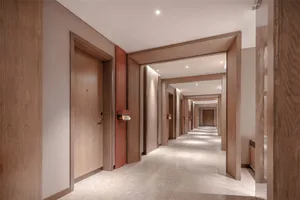 A modern hallway interior with wooden paneling and marble flooring.