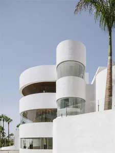 Modern building with white walls, glass windows, and concrete elements.