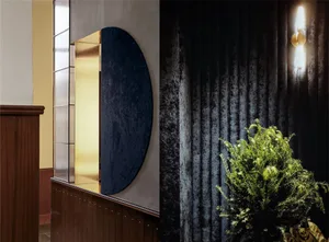 Decorative green plants framed by velvet curtains within an elegant interior design setting.