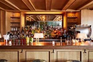 A photograph of a wooden-panelled restaurant bar.