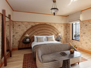 Modern bedroom with oak furniture and leather details