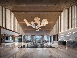 Modern hotel lobby featuring marble, wood, and metal materials.