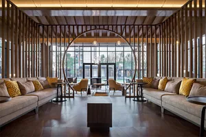 Modern, open-concept lobby featuring wooden accents and glass walls.