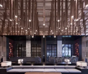 A minimalist lobby interior with wooden structural elements and lighting.