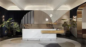 A modern reception desk made of marble, metal, and wood