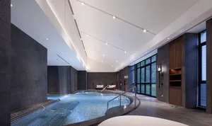 Modern, minimalist spa pool area with concrete walls and flooring.
