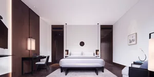 A minimalist bedroom featuring wood, leather, and metal materials.