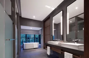 A spacious, modern bathroom with concrete walls and a large freestanding bathtub.