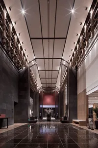 Modern hotel lobby interior with glass walls and concrete flooring