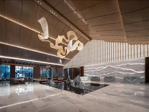 A luxurious, minimalist lobby featuring contemporary marble materials and sleek design elements.
