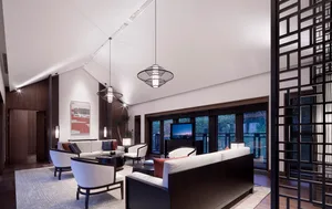 Modern, white leather living room with minimalistic decor and large windows
