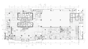 Detailed office building floor plan showing various departments and spaces, including offices, meeting rooms, and communal ar