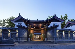 A traditional Chinese architectural structure with wooden beams, stone pillars, and clay tiles.