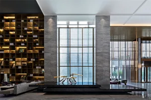 A modern, spacious lobby featuring a sleek marble and glass design