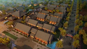 Aerial view of traditional brick townhouses with green roofs and windows.