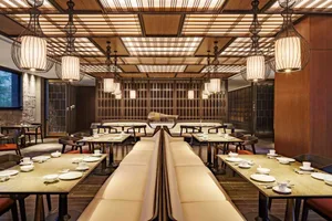 Modern restaurant interior featuring wooden and metallic elements.