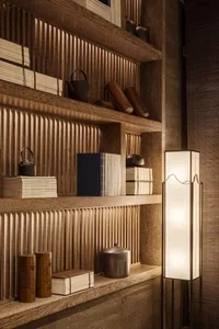 A traditional wooden bookshelf filled with books and decorative items.