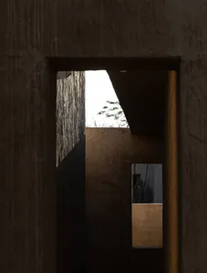 Concrete interior space with minimalistic design elements and natural light.
