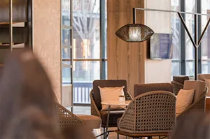 Modern lobby with woven furniture and wooden accents.