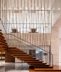 Modern staircase with decorative wooden steps and hanging ropes