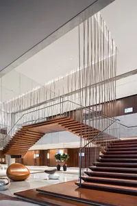 A modern lobby featuring wood and glass materials and a minimalist design.